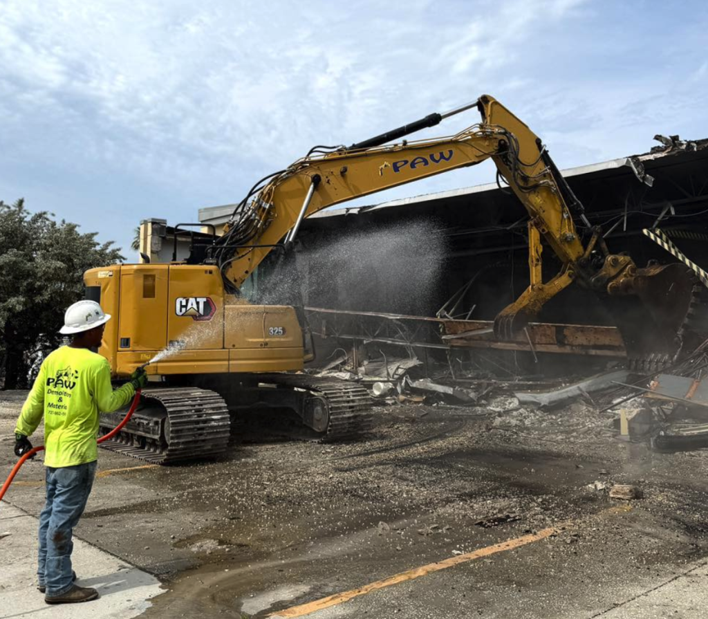 Excavator tearing down a warehouse at PAW demolition site